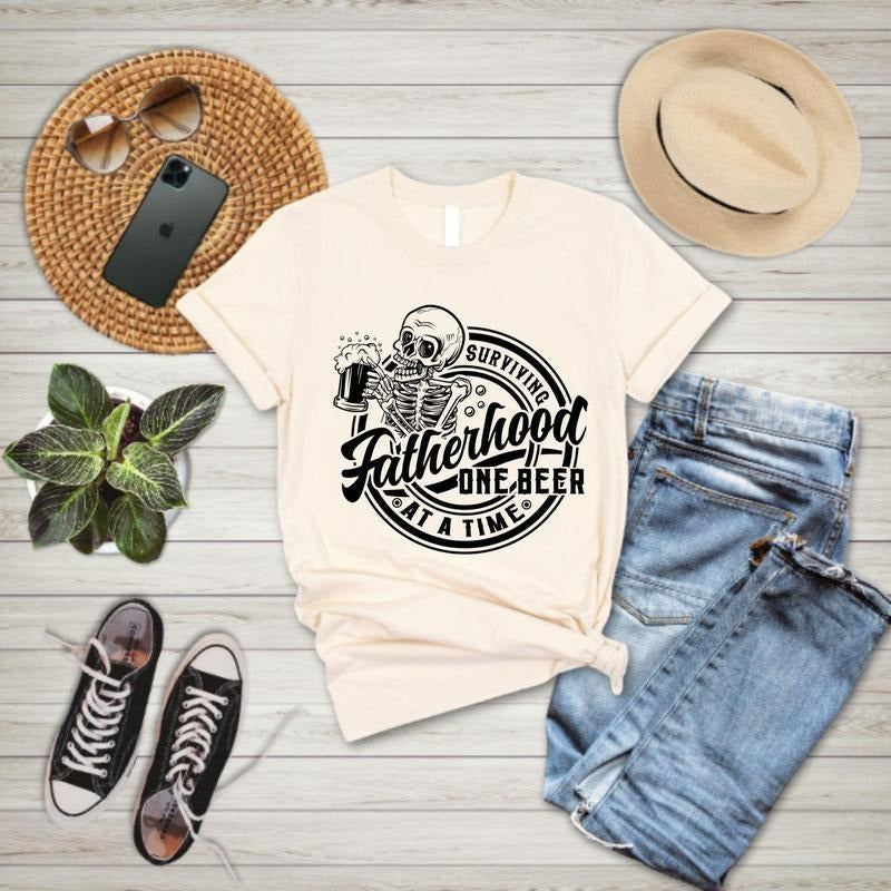 Fatherhood Surviving One Beer Time Funny Father - Adult & Kids T-Shirts, Sweatshirts & Hoodies apparel design preview 1