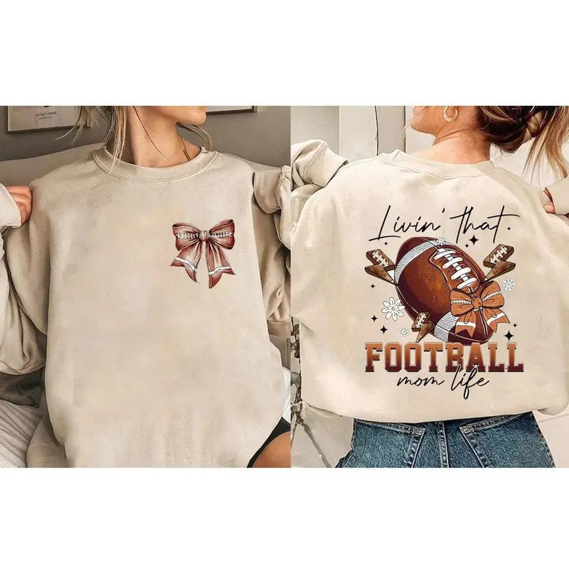 Football Bow Livin That Mom Life Sublimation Trending - Adult & Kids T-Shirts, Sweatshirts & Hoodies apparel design preview 1