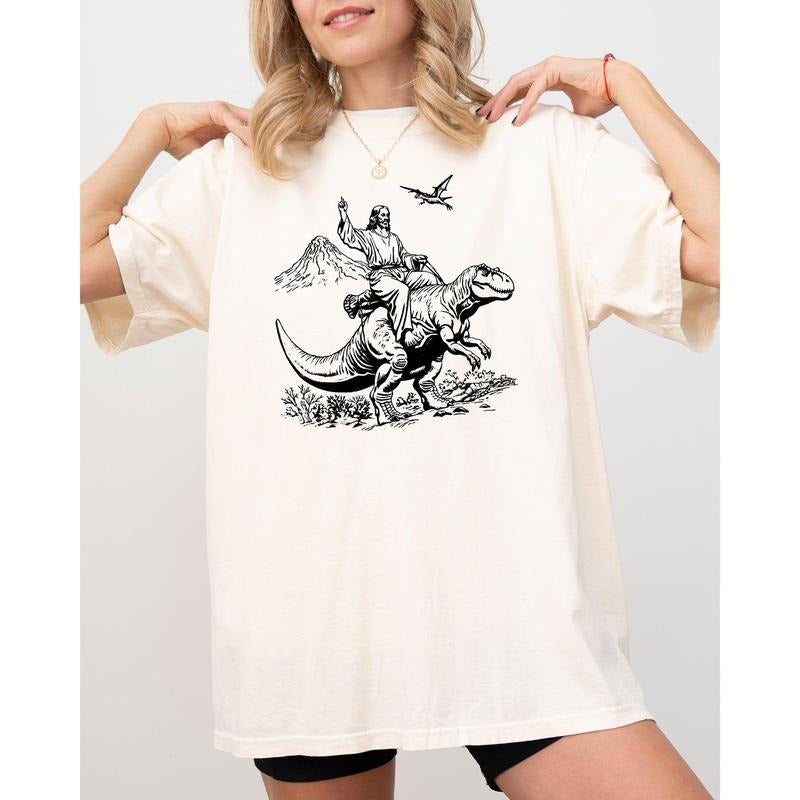 Jesus Riding Dinosaur Tyrannosaurus Rex Funny Meme - Adult & Kids T-Shirts, Sweatshirts & Hoodies apparel design preview 1