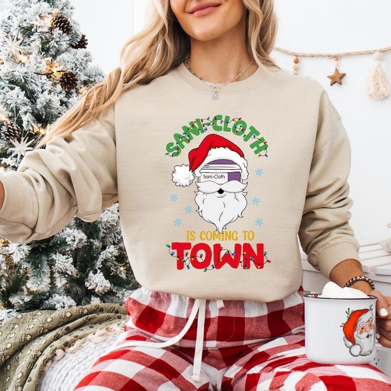 Sani Cloth Is Coming Town Santa Nurse ICU ER Xmas - Adult & Kids T-Shirts, Sweatshirts & Hoodies apparel design preview 1