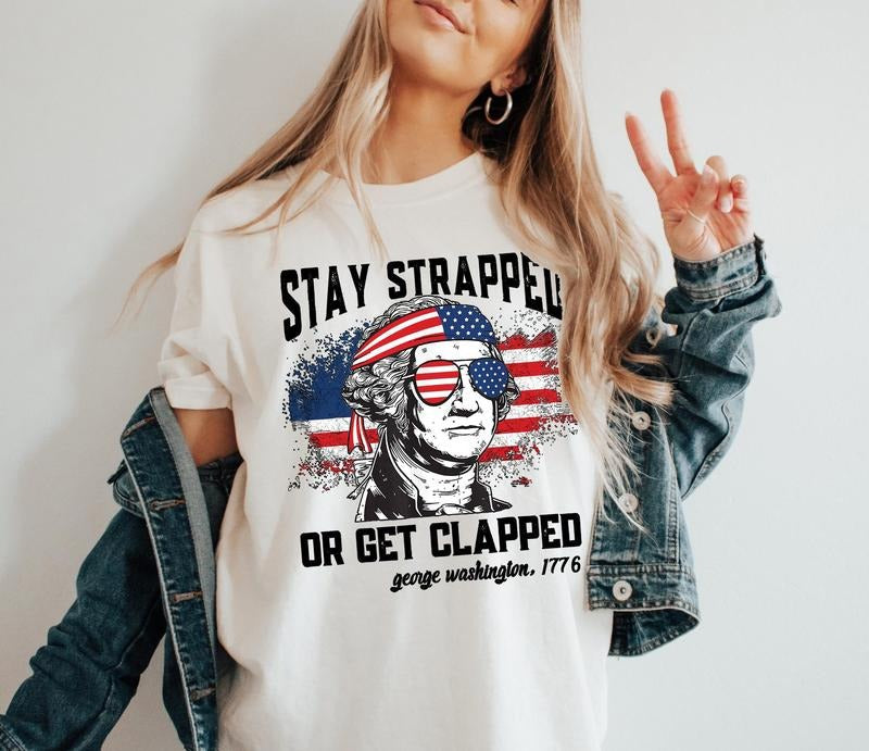 Stay Strapped Get Clapped Funny George Washington Usa - Adult & Kids T-Shirts, Sweatshirts & Hoodies apparel design preview 1