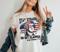 Stay Strapped Get Clapped Funny George Washington Usa - Adult & Kids T-Shirts, Sweatshirts & Hoodies apparel design preview 1